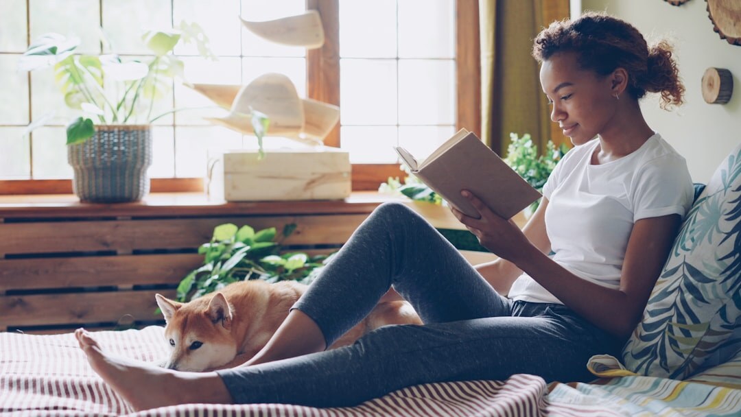 woman reading book at home